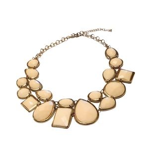 Awesome necklace with variety of beige shapes.